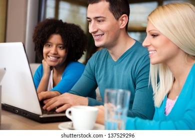 Students  sitting in cafe and  using laptop - Powered by Shutterstock