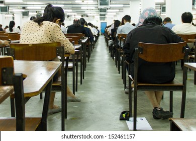 Students Sitting In An Exam Hall Doing An Exam In University