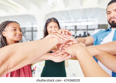 Students as start-up founders putting their hands together as team for motivation - Shutterstock ID 674368105