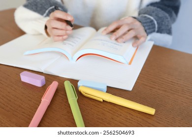 Students studying by looking at reference books