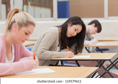 Students taking an exam in exam hall in college