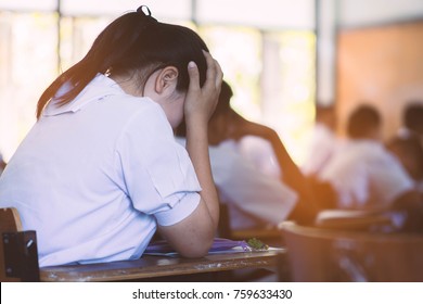 Students Taking Exam With Stress In School Classroom.