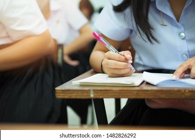 Students Taking Exam Or Written Test In The Classroom. Educational Or Academic Picture Of Learners At Test Center Having Writing Assignment In High School, Vocational Institute, College, Or University