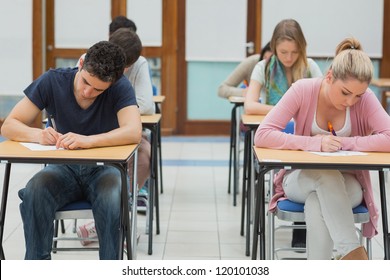 Students Taking Exams In Exam Hall In College