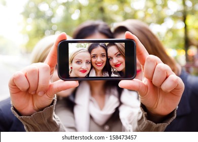 Students taking a self portrait with smart phone.