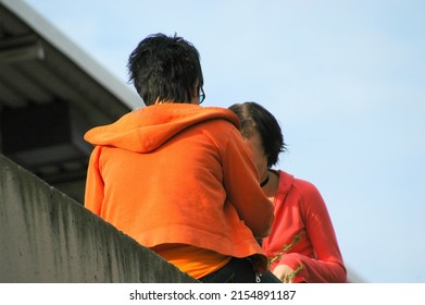 Students Talking Together At Lunch Break Outside.