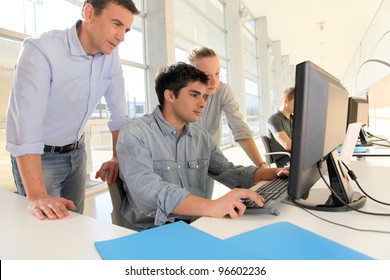 Students With Teacher In Front Of Desktop Computer