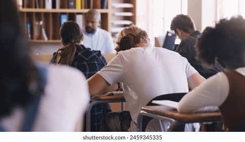 Students, test and exam with writing, study and support for education and knowledge. Man, teenager and classroom with learning, teacher and high school development for future growth for question - Powered by Shutterstock