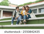 Students at university with fun for learning,Walking,laughing and bonding and talking.asian group of gen z friends student giving high five outdoor with books ready for education at college campus.