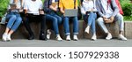 Students using laptop and books, preparing for lectures outdoors, crop