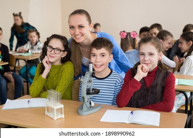 Students using science beakers and a microscope at the elementary school - Powered by Shutterstock - Get 15% off with code: PIKWIZARD15