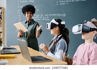 Students using VR glasses at IT lesson - Powered by Shutterstock