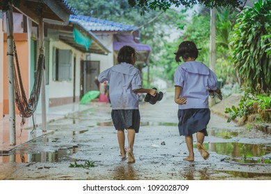 Students walk to the flood after rain in school. - Shutterstock ID 1092028709