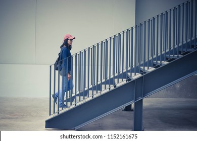 Students walk up the stairs.