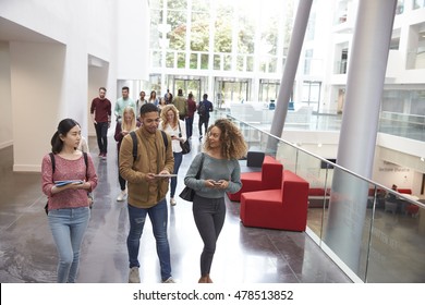 Students walk and talk using mobile devices in university - Powered by Shutterstock