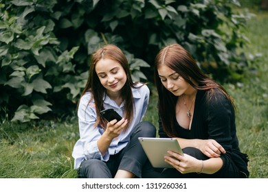 Students Walking And Talking And Use Tablet