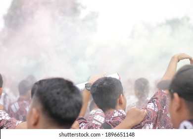 
the students who were celebrating graduation with smoke