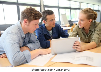 Students working on digital tablet at school