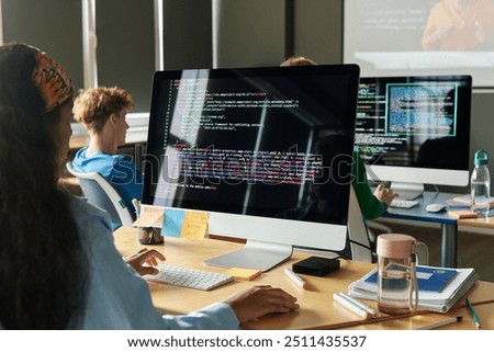 Students writing computer code during programming class in school or college, copy space