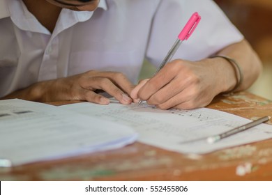 Students Writing Test Exam On Paper For Admissions In High School With Uniform Student In School Classroom Of Thailand, Exam Student Background And Education Concept