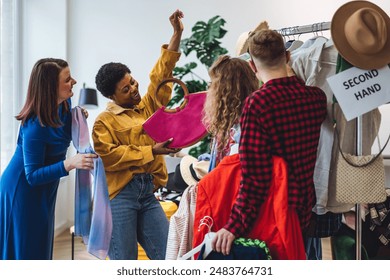 Students, young attractive people shopping in secondhand store, trying vintage clothes, bargain hunting. Sustainable lifestyle of generation z, eco friendly conscious consumerism, consignment stores - Powered by Shutterstock