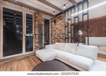 Studio apartment with exclusive design. Brick walls, dark steel batteries. The space is 
divided by an elegant partition into a living room and a bedroom.
