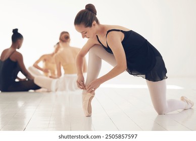 Studio, ballet and girl with shoes for tying, performance and practice for dance competition. Ballerina, student and slippers in class for rehearsal, practice and talent of dancer in art academy - Powered by Shutterstock