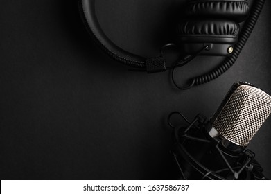Studio Black Studio Microphone With Studio Headphones On A Black Background. Banner. Radio, Work With Sound, Podcasts.