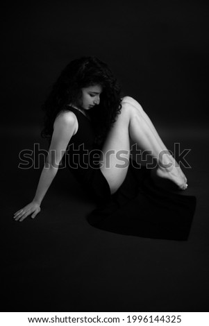 Similar – Young brunette woman in black lingerie lying on the floor