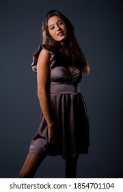 Studio Body Shot Of A Fashion Female Model Posing In Rose Satin Slip Skirt