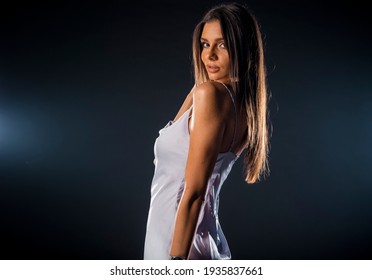 Studio Body Shot Of A Fashion Female Model Posing In White Satin Slip Skirt