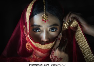 Studio Close Up Head Shot Portrait Of Asian Woman In Tradition Indian Costume With Sari, Veil And Henna Looking At Camera