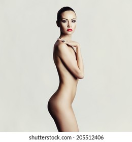 Studio fashion photo of elegant naked lady