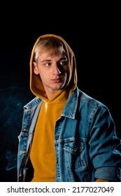 Studio Fashion Portrait Of A Handsome Guy Wearing Jeans Jacket And Yellow Hoodie