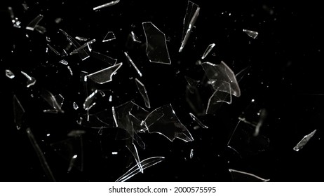 Studio full-frame wide plate shot of window glass pane shattering and breaking on black background. Real smash explosion at high speed as action concept template and overlay element.