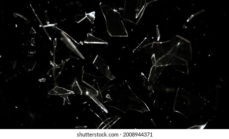 Studio full-frame wide plate shot of window glass pane shattering and breaking on black background. Real smash explosion at high speed as action concept template and overlay element. - Shutterstock ID 2008944371
