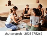 Studio, group and people with discussion for yoga, mindfulness and holistic progress with feedback tips. Class, women or men as friends with notebook, healing information or support for mental health