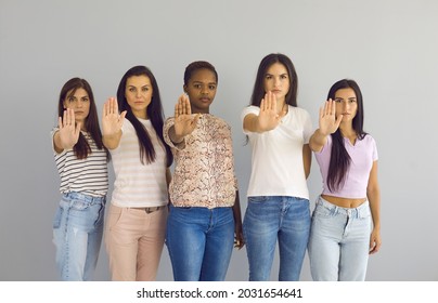 Studio Group Team Portrait Five Women With Confident Determined Face Expression Doing Stop Hand Palm Sign Gesture Standing Isolated On White Grey Background. Say No To Stereotypes Or Family Violence