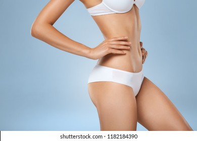 Studio HD Capture Of A Unrecognizable Young Woman Torso In Underwear. Perfect Slim Tanned Body - An Example Of Sports, Dieting, Fitness Or Plastic Surgery And Aesthetic Cosmetology