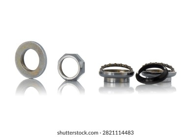 Studio horizontal row layout of disassembled threaded bicycle headset components featuring knurled washer, locknut, steel cups, ball bearing retainers, rubber seal, and soft reflection on isolated white background showcasing cycling steering repair hardware.