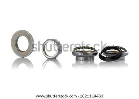 Studio horizontal row layout of disassembled threaded bicycle headset components featuring knurled washer, locknut, steel cups, ball bearing retainers, rubber seal, and soft reflection on isolated white background showcasing cycling steering repair hardware.