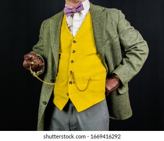 Studio Image Of Man In Vintage Suit And Leather Gloves Holding Pocket Watch. Concept Of Classic And Eccentric British Gentleman Stereotype