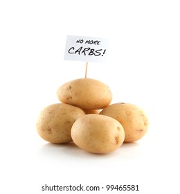 Studio Image Of Raw Potatoes With Placard Stating 