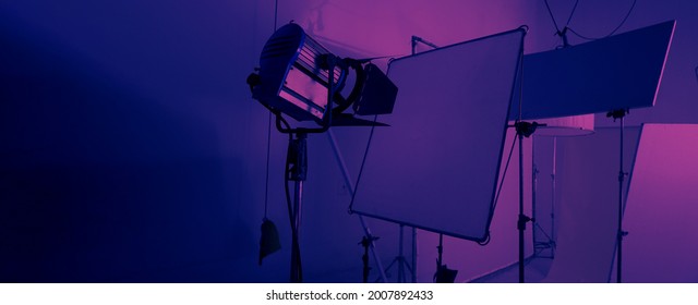 Studio Light Equipments For Photo Or Film Movie Video. Light Set For Professional Shooting Studio Background. LED Flood Light And Spot Light For Video Production Studio. Setup Barn Door And Softbox.