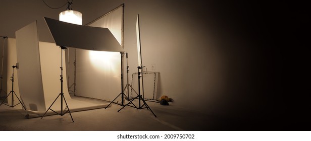 Studio Light Equipments For Photo Or Film Movie Video. Light Set For Professional Shooting Studio Background. LED Flood Light And Spot Light For Video Production Studio. Setup Barn Door And Softbox.