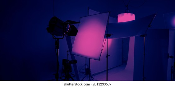 Studio Light Equipments For Photo Or Film Movie Video. Light Set For Professional Shooting Studio Background. LED Flood Light And Spot Light For Video Production Studio. Setup Barn Door And Softbox.