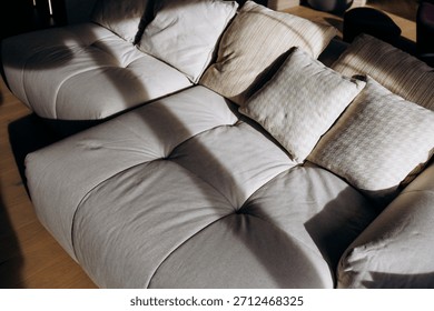 Studio lighting emphasizes seams and plush texture of sofa
