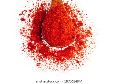 Studio Lighting. Red Paprika Spice On A Wooden Spoon, On A White Background. There Is A Shadow. Close-up. No Isolation