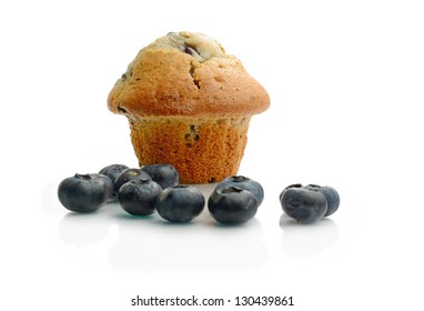 Studio Macro Of Blueberry Muffin And Fresh Scattered Blueberries With Soft Shadows On A White Surface. Copy Space.