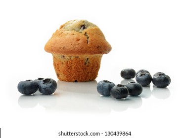 Studio Macro Of Blueberry Muffin And Fresh Scattered Blueberries With Soft Shadows On A White Surface. Copy Space.